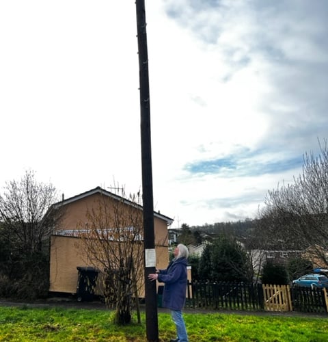 Resident Sue Mistlebrook with a new pole on the corner of Furze Road and Rush Way, Bridgetown