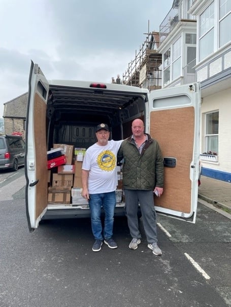 Darren Hopley, Dartmouth Yacht Club Manager, helping Mark Paine, from the Ukraine Sunflower Aid charity, load boxes onto his van ready to be taken into Ukraine