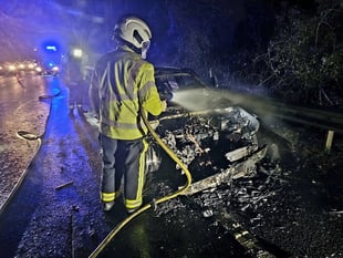 Firemen put out car blaze on A38