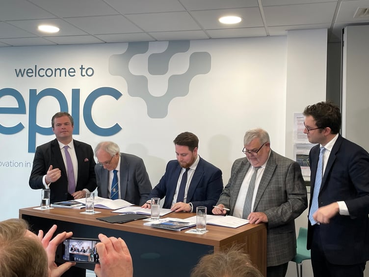 Council leaders, Cllr John Hart, Cllr David Thomas and Minister for Levelling Up Luke Young MP signing the Devon and Torbay devolution deal