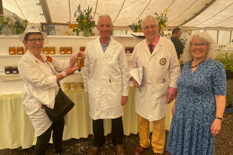 In the Beekeeping marquee, from left, Judge Suzette Perkins from Langport, Somerset, steward Chris Carr and judges Peter and Marian Guthrie from Brecon, Mid Wales. AQ 2814