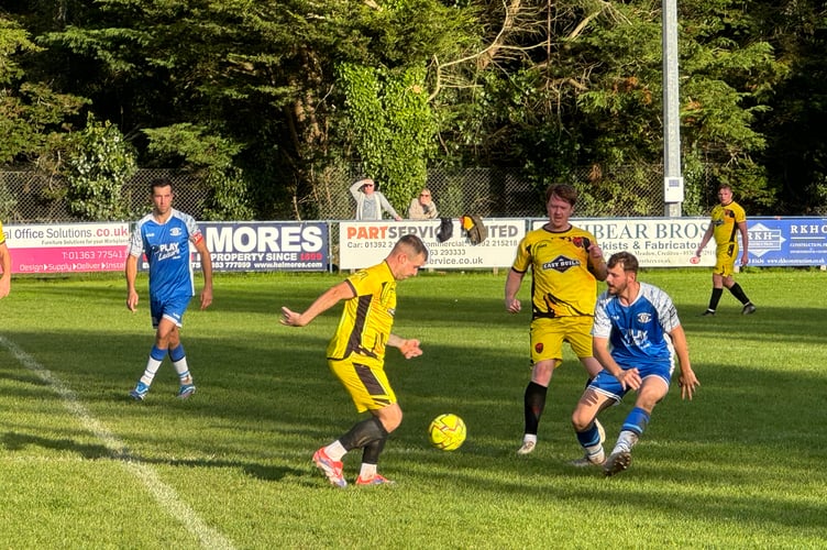 Crediton, in blue, and Stoke Gabriel and Torbay Police, going for the ball.  AQ 6326