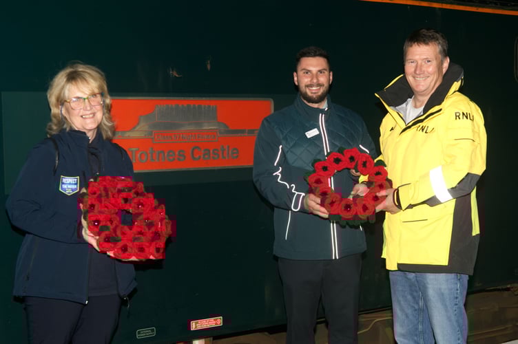 RNLI volunteers Gaynor Williams and Tony Rendle with train manager Joe Lorusso and the knitted poppy wreaths. (Picture: RNLI/Phil Monckton)
