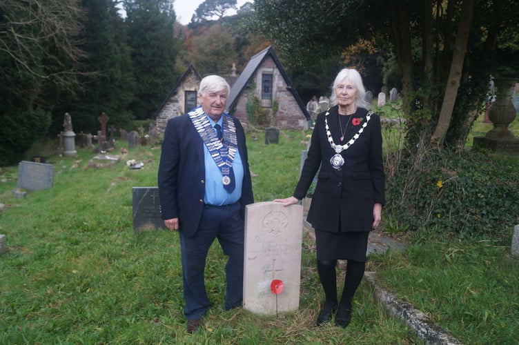 Old Dartmothians President Hilary Bastone and Kingswear Parish Council Chairman Cllr Lynne Maurer lay tributes at the Kingswear Cemetery war graves  
