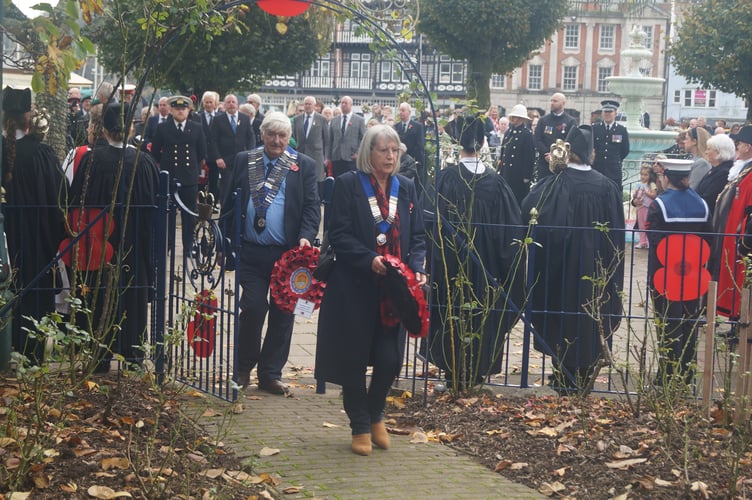 Old Dartmothians President Hilary Bastone and President of the Old Dartmothians Ladies Section Sue Pepperell lay wreaths at the war memorial.