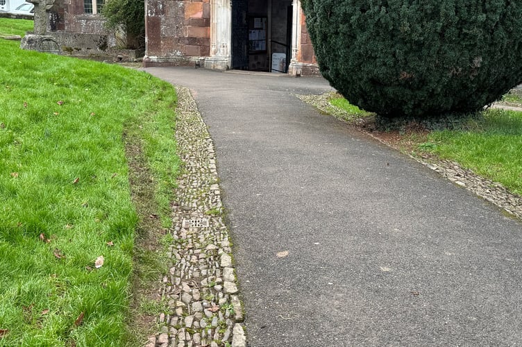 Tyre tracks on the verge of the church pathway.  AQ 2489
