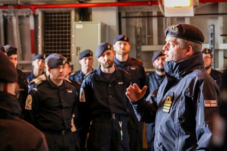 Commanding Officer, Commander James Wallington-Smith with members of the ship's company