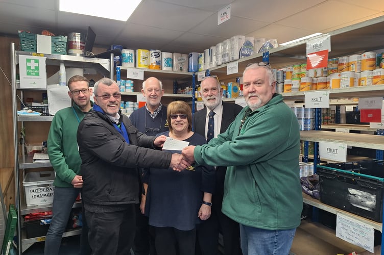Plymouth club President Lion Lionel Marsh presents the £500 cheque to Mark Haydon (far right) of the Plymouth Foodbank watched by (left to right) Andrew Denham (Plymouth Foodbank) and Lions David Turvey, Pam Greenwood (Community Service chair), and Immediate Past President Bob Dight.