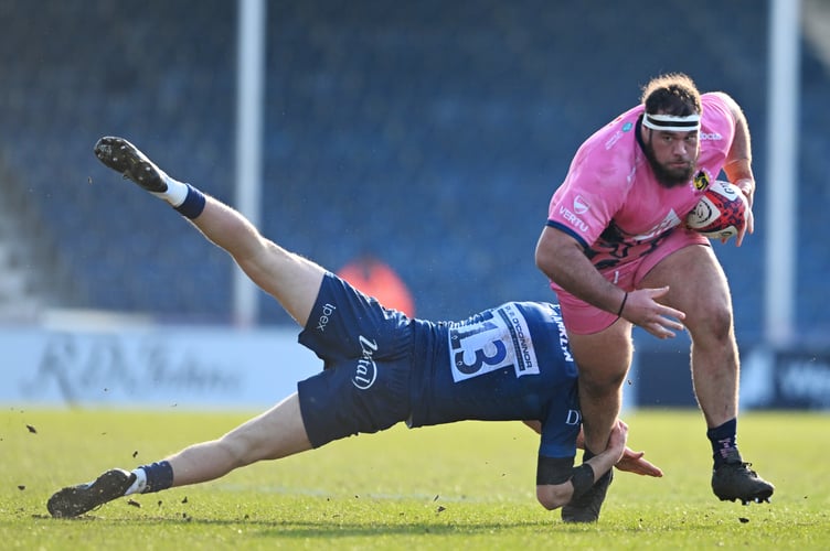 Exeter Chiefs prop Josh Iosefa-Scott powers his way past Sale Sharks centre Joe Bedlow during their Premiership Rugby Cup clash at Sandy Park