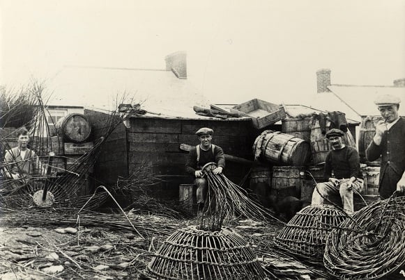 Fishermen making crab pots at Beesands. Alfred Hutchings in centre, approx 1920. Two men on right possibly Prettejohn brothers who drowned. 