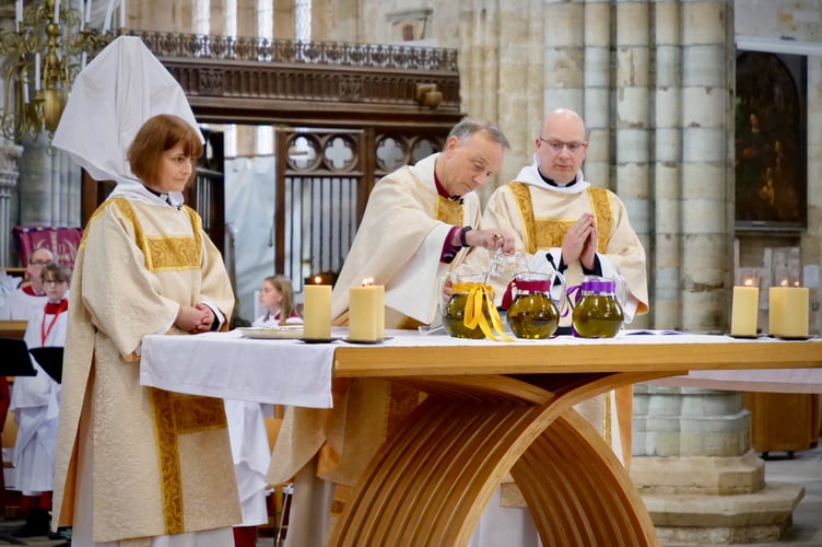 Bishop of Exeter, the Rt Rev Dr Mike Harrison, centre, during the Maundy Thursday Chrism Eucharist service at Exeter Cathedral.
