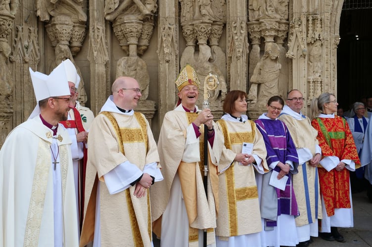 The Bishop of Exeter, the Rt Rev Dr Mike Harrison, laughing with other clergy after the Chrism Service.
