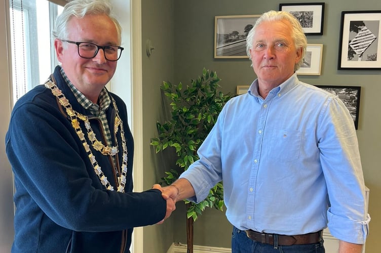 New Salcombe Mayor Cllr Jasper Evans receives the chains of office from outgoing Mayor Cllr Mark Goodey