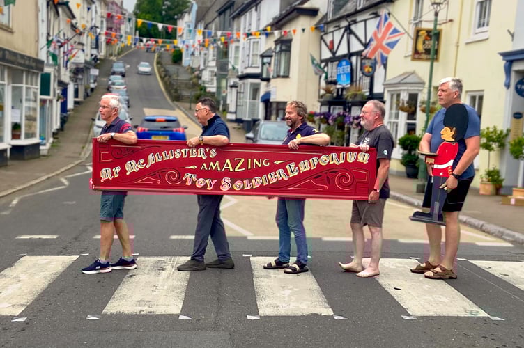 Marching Mr McAllister's Toy Shop sign through Modbury to new store location.