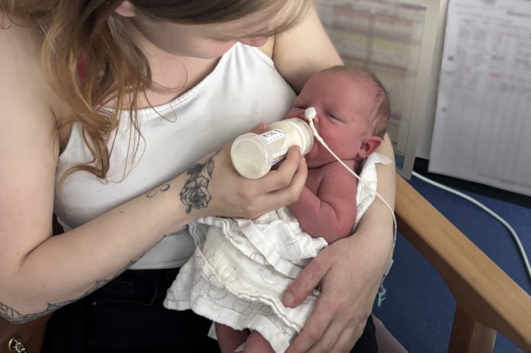 Katelyn and baby Macey-Mai, in hospital. A mum fears people will think her baby is "dirty" after a rare skin condition has covered her tot's back in a giant birthmark that is "constantly bleeding" Two-month-old Macey-Mai was born with giant congenital melanocytic nevus (GCMN), a benign, tumour-like malformations resulting from faulty development of pigment cell. Her mum, Katelyn Clarke, 23, said nothing was detected at her ultrasounds until she gave birth to the tot naturally on May 7 2025, at University Hospitals Plymouth, weighing 5lbs 15 oz. Katelyn and partner, Dainen Milne, 23, were "completely shocked" when medics spotted the dark mark covering her entire back - as well as the sides of her stomach, scalp, legs and arms.