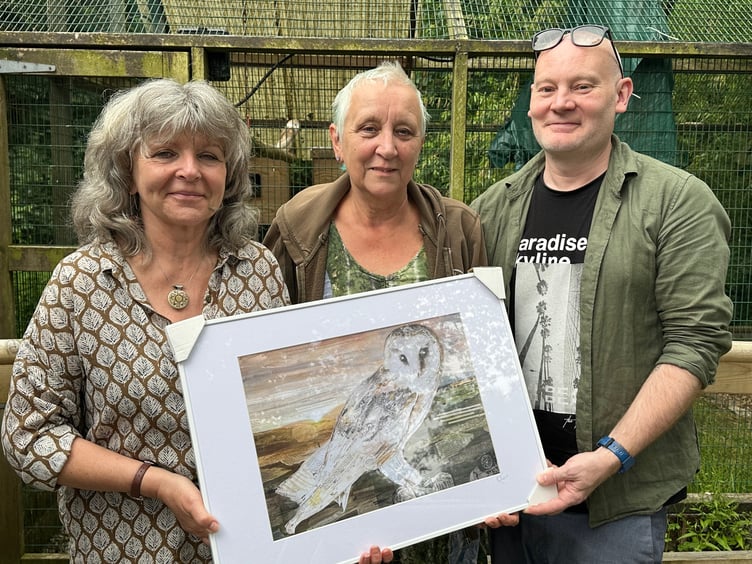 Artist Glen Middleham presenting the print to Barn Owl Trust staff