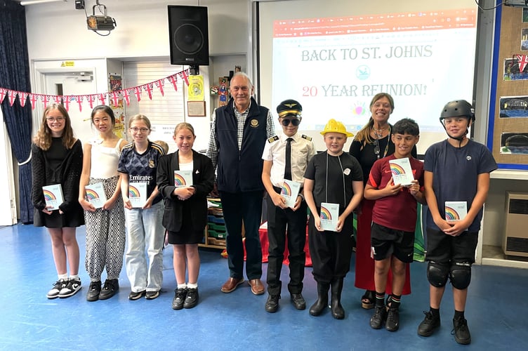 Some year 6 pupils at St John the Baptist Primary School, Dartmouth, and their teacher, Mrs Brown, after receiving their “Book for Life” from Bernard Young President of Dartmouth Rotary at their final assembly.