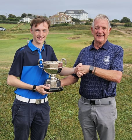 Louis-Paul Martin is presented with the Allcomers Cup by club captain John Rogers