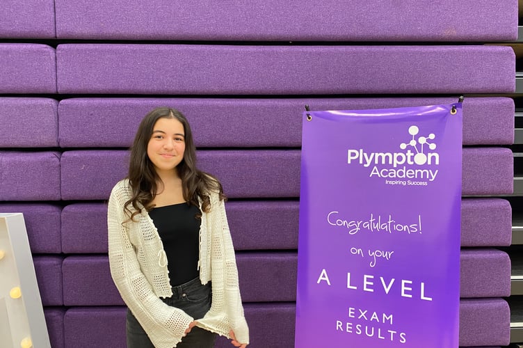 student at Plympton Academy beams with pride after collecting results