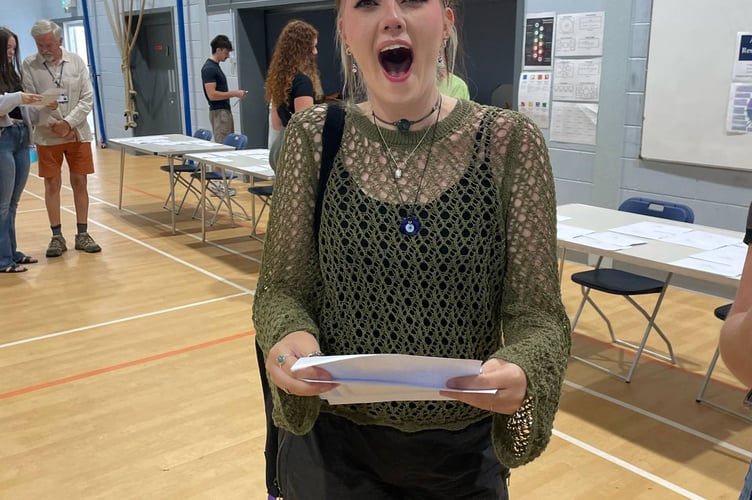 Merly T  beams with pride after collecting results at PHSG