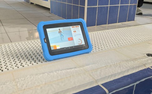The Good Boost programme uses waterproof tablets at the poolside to help a person with Parkinson’s follow safe and structured movements in the water
