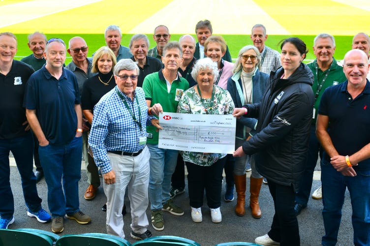 Club chairman of the Plymouth Argyle Vice Presidents Club, John McNulty, hands over a cheque to Argyle Women's head coach Marie Hourihane at Home Park