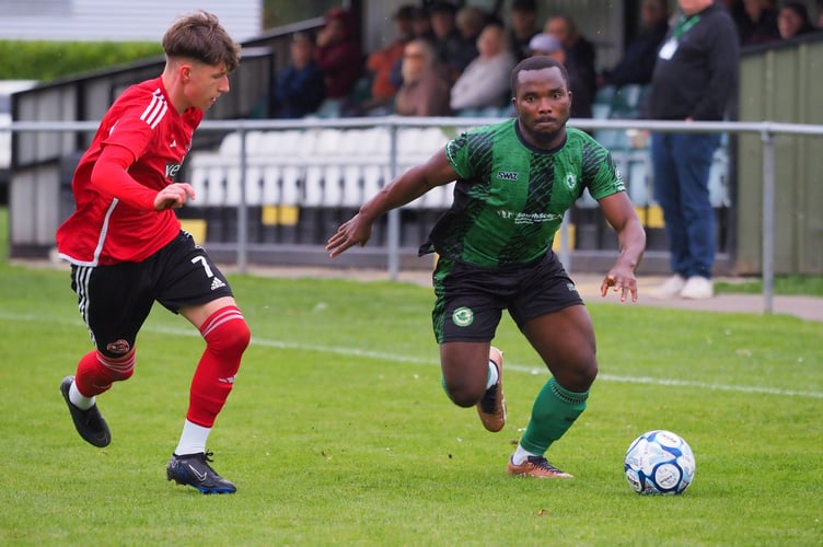 Kaycee Ogwu driving Ivybridge Town forward against Totton