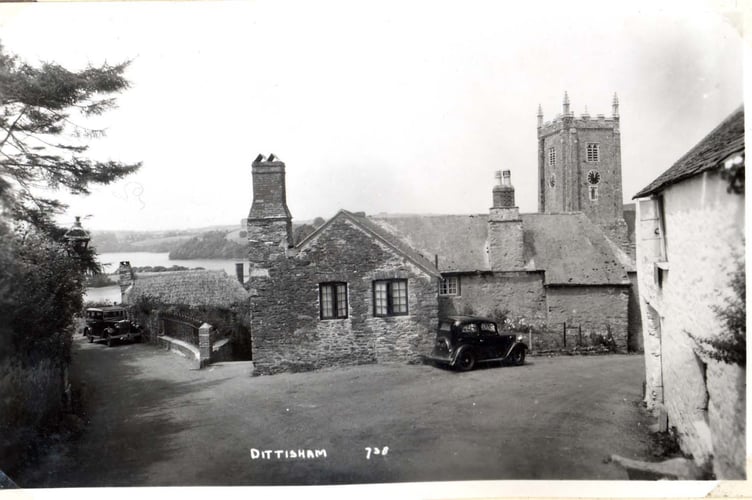 Stone walled house in front of Dittisham Church. River Dart in background, two cars in road. c1950