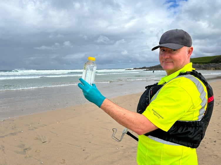 An Environment Agency officer taking a bathing water sample earlier this year