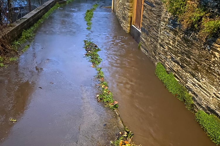 Heavy rain has caused the leat to overflow. 