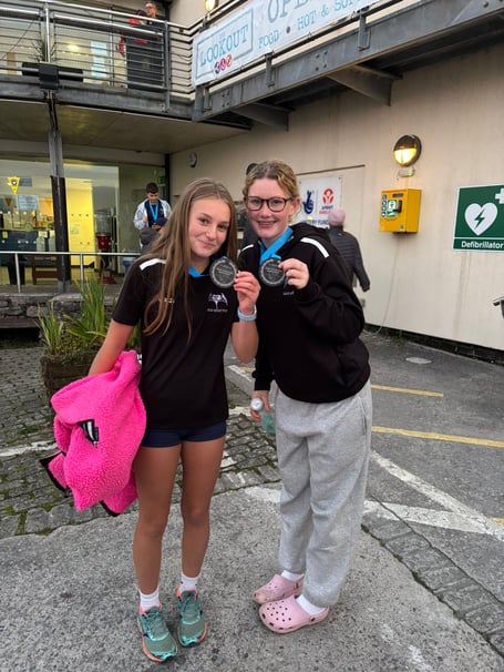 Flo (right) with her Junior International Championships 2024 gig rowing medal