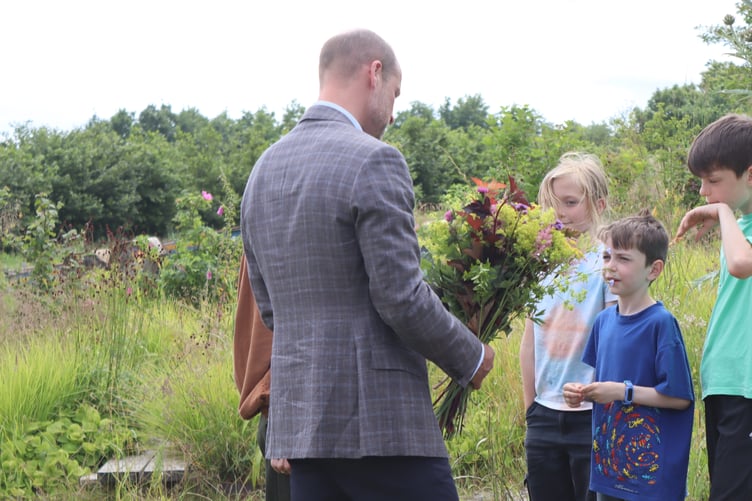 HRH receiving flowers from the Apricot Centre