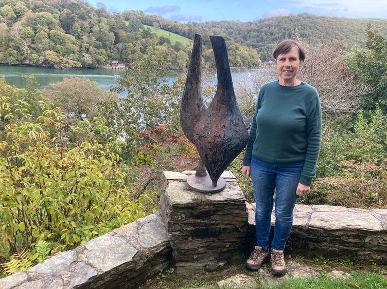 Sarah McCrum next to one of her mother's sculptures